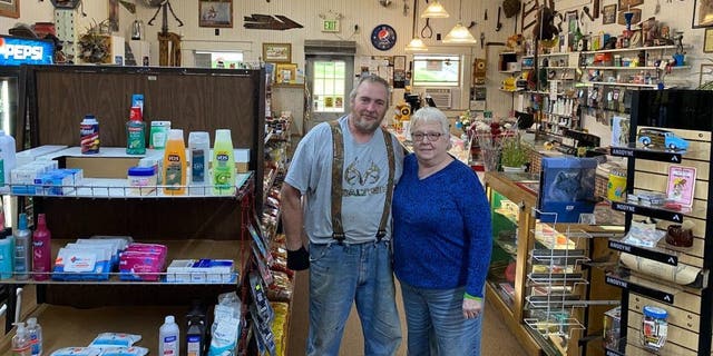 Store owners Alan and Sharlene Weidner stand in the center of their shop.