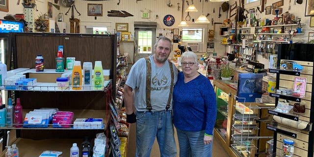 Store owners Alan and Sharlene Weidner stand in the center of their shop.
