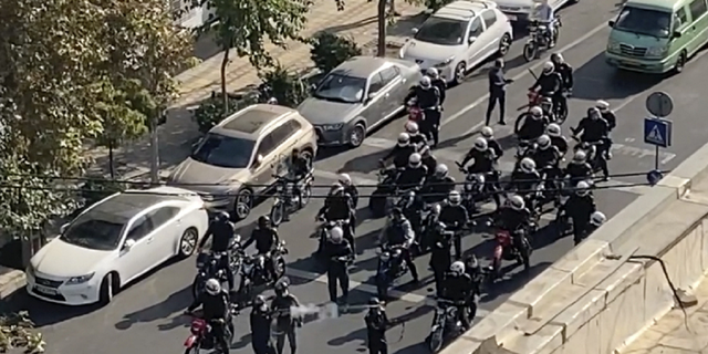 Iranian police arrive to disperse a protest to mark 40 days since the death in custody of 22-year-old Mahsa Amini, whose tragedy sparked Iran's largest anti-government movement in more than a decade, in Tehran, Iran.