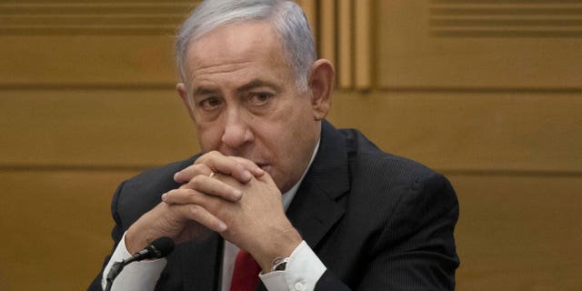 FILE - Former Israeli Prime Minister Benjamin Netanyahu speaks to right-wing opposition party members, at the Knesset, Israel's parliament, in Jerusalem, June 14, 2021. Netanyahu was hospitalized on Wednesday, Oct. 5, 2022, after feeling unwell during the Jewish fasting day of Yom Kippur. (G3 Box News Photo/Maya Alleruzzo, File)