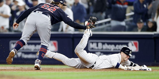 Josh Donaldson of the New York Yankees is tagged out at first by Josh Naylor of the Cleveland Guardians during the American League Division Series at Yankee Stadium on Oct.  11, 2022.