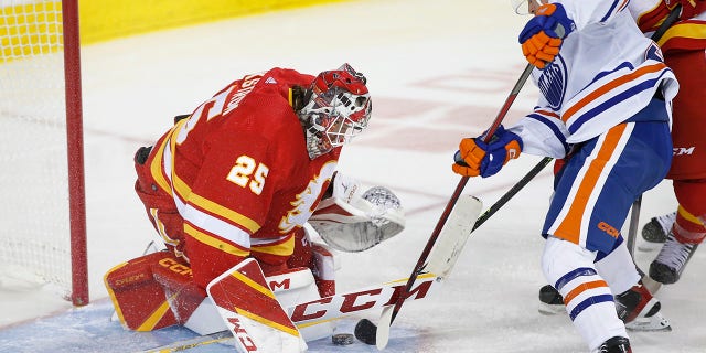 Flames goalie Jacob Markstrom makes a save against Edmonton Oilers' Kailer Yamamoto in Calgary, Alberta, Saturday, Oct. 29, 2022.