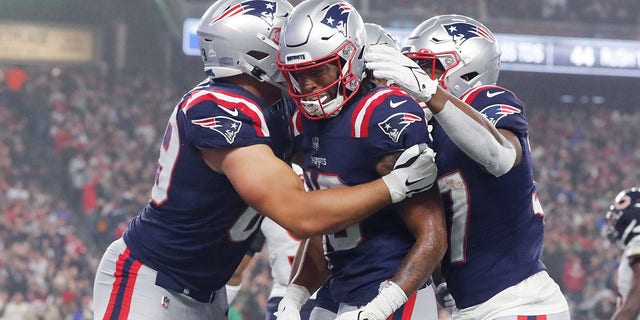 New England Patriots wide receiver Jacobi Myers (center) is congratulated after scoring a touchdown in the first half of an NFL football game against the Chicago Bears on Monday, Oct. 24, 2022 in Foxborough, Massachusetts. .