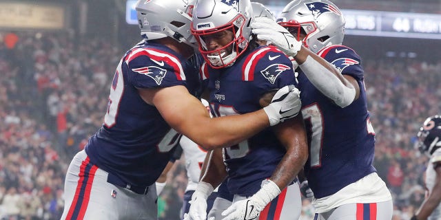 New England Patriots wide receiver Jakobi Meyers, center, is congratulated after his touchdown during the first half of an NFL football game against the Chicago Bears, Monday, Oct. 24, 2022, in Foxborough, Mass.