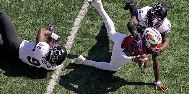 Kansas quarterback Jalon Daniels is sacked by TCU linebacker Jamoi Hodge (6) during the first half on Oct. 8, 2022, in Lawrence, Kansas.