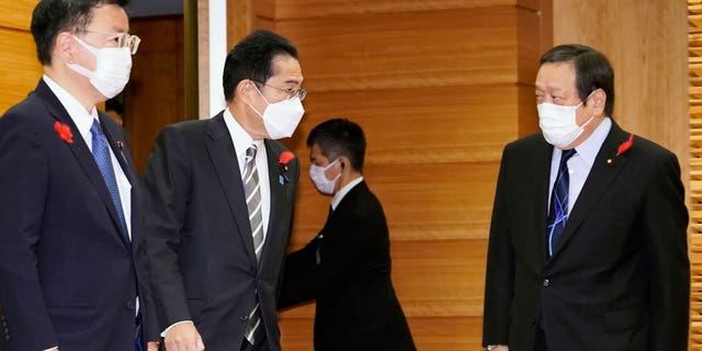 Japan's Prime Minister Fumio Kishida, second left, talks to Defense Minister Yasukazu Hamada, right, as they gather for a cabinet meeting at Kishida's office in Tokyo Friday, Oct. 14, 2022. North Korea early Friday fired an additional ballistic missile and 170 rounds of artillery shells toward the sea and flew warplanes near the tense border with South Korea. "Whatever the intentions are, North Korea's repeated ballistic missile launches are absolutely impermissible and we cannot overlook its substantial advancement of missile technology," Hamada said.  (Keisuke Hosojima/Kyodo News via AP)