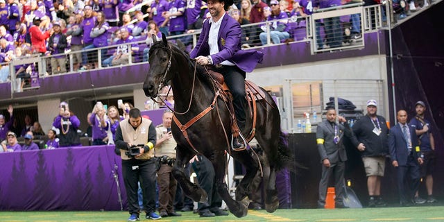 Former Vikings defensive end Jared Allen rides a horse onto the field before being inducted into the team's Ring of Honor at halftime during the game between Minnesota and the Arizona Cardinals, Sunday, Oct. 30, 2022, in Minneapolis.