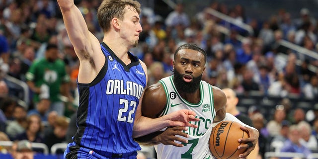 Boston Celtics guard Jaylen Brown (7) drives into a basket guarded by Orlando Magic forward Franz Wagner (22) on Oct. 22, 2022 at the Amway Center in Orlando, Fla.