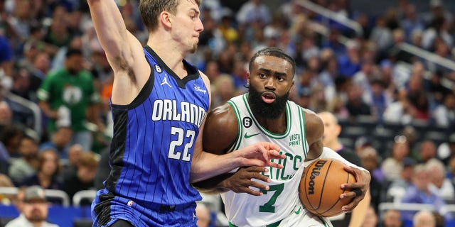 Boston Celtics guard Jaylen Brown (7) drives into a basket guarded by Orlando Magic forward Franz Wagner (22) on Oct. 22, 2022 at the Amway Center in Orlando, Fla.