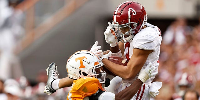 Alabama wide receiver Jermaine Burton (3) makes a catch as he's defended by Tennessee defensive back Christian Charles (14) during the second half of an NCAA college football game Saturday, Oct. 15, 2022, in Knoxville, Tenn.