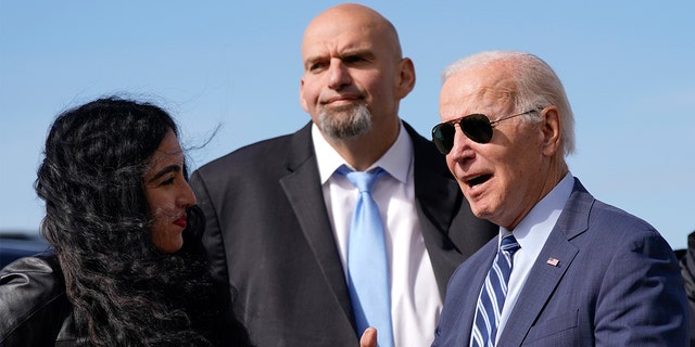 President Biden talks with Pennsylvania Lt. Gov. John Fetterman, a Democratic candidate for U.S. Senate, second from left, and his wife Gisele Barreto Fetterman, left, as he arrives, Thursday, Oct. 20, 2022, at the 171st Air Refueling Wing at Pittsburgh International Airport in Coraopolis, Pennsylvania. 