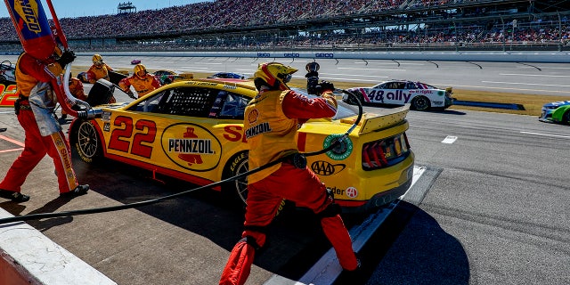 The pit crew works on Joey Logano's car during the YellaWood 500 at Talladega Superspeedway on Oct. 2, 2022, in Talladega, Alabama.