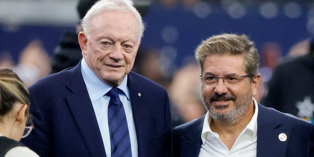 Dallas Cowboys team owner Jerry Jones and Dan Snyder, co-owner and co-CEO of the Washington Commanders, pose for a photo on the field during warmups before a game in Arlington, Texas, Oct. 2, 2022.