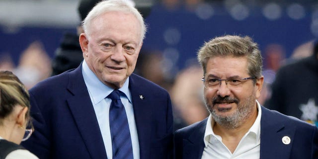 Dallas Cowboys team owner Jerry Jones and Dan Snyder, co-owner and co-CEO of the Washington Commanders, pose for a photo on the field during warmups before a game in Arlington, Texas, Oct. 2, 2022.