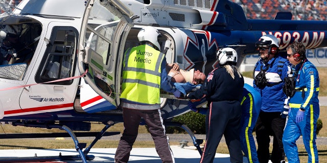 Driver Jordan Anderson is loaded into a helicopter after a fiery crash during the NASCAR Trucks Chevrolet Silverado 250 auto race, Saturday, Oct. 1, 2022, in Talladega, Alabama. 