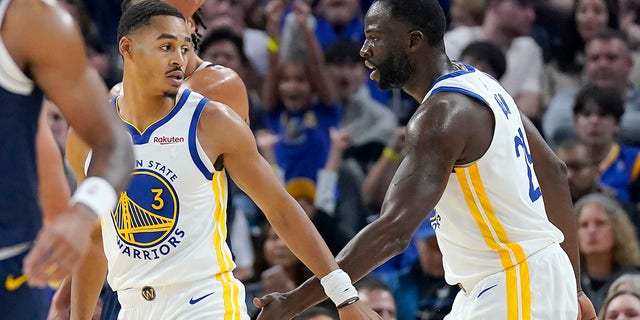 Golden State Warriors' Jordan Poole (3) is congratulated by Draymond Green during the game against the Denver Nuggets in San Francisco on Oct. 14, 2022.