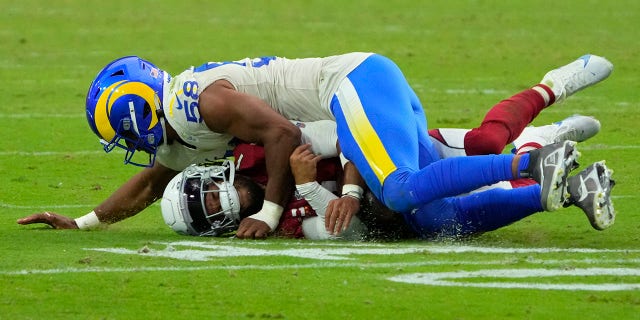 Los Angeles Rams linebacker Justin Hollins (58) tackles Arizona Cardinals quarterback Kyler Murray (1) during the second half of an NFL football game, Sunday, Sept. 25, 2022, in Glendale, Ariz.