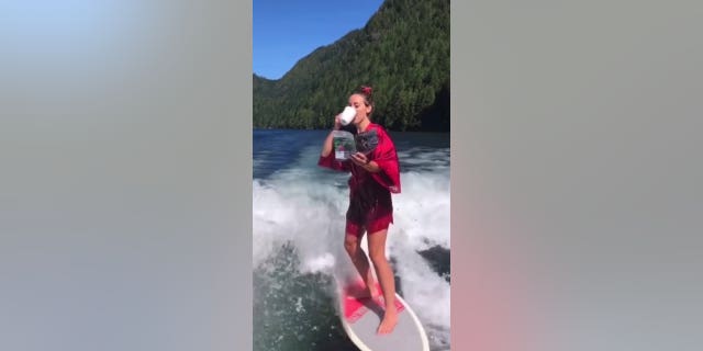 "Obviously safety precautions are in place," said Lee, "and I make sure I can swim in heels. I don't do any tricks I don't think I can handle." In this image, she's shown wakesurfing while sipping coffee and reading a magazine.