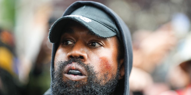 Kanye West, a.k.a Ye, is seen wearing a Balenciaga boxing mouthguard, outside Givenchy, during Paris Fashion Week on Oct. 2, 2022, in Paris, France. 