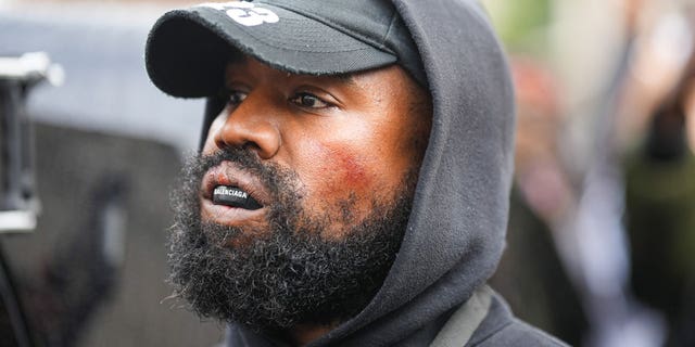Kanye West aka Ye is seen wearing a Balenciaga boxing mouthguard, outside Givenchy, during Paris Fashion Week - Womenswear Spring/Summer 2023 - Day Seven on October 02, 2022, in Paris, France. 