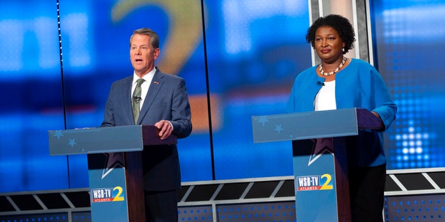 Republican Georgia Gov. Brian Kemp, left, and Democratic challenger Stacey Abrams face off in a televised debate, in Atlanta, Sunday, Oct. 30, 2022.