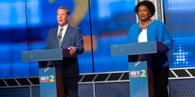 Republican Georgia Gov. Brian Kemp, left, and Democratic challenger Stacey Abrams face off in a televised debate, in Atlanta, Sunday, Oct. 30, 2022.