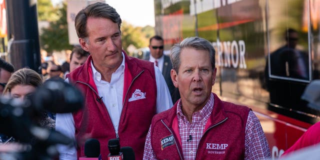 Gov. Brian Kemp, right, speaks to the media at a campaign event attended by Virginia Gov. Glenn Youngkin, left, on September 27, 2022 in a northern Atlanta suburb.