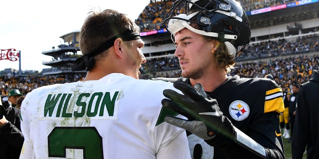 Zach Wilson of the New York Jets and Kenny Pickett of the Pittsburgh Steelers meet after the Jets beat the Steelers, 24-20, at Acrisure Stadium in Pittsburgh on Oct. 2, 2022.