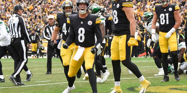 Pittsburgh Steelers quarterback Kenny Pickett, #8, celebrates beside teammates after scoring a touchdown against the New York Jets during the second half of an NFL football game, Sunday, Oct. 2, 2022, in Pittsburgh.