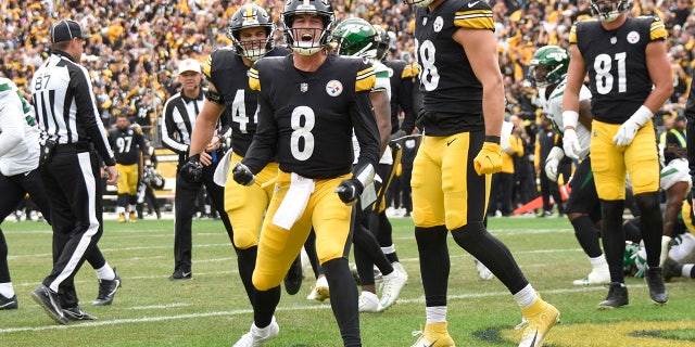 Pittsburgh Steelers quarterback Kenny Pickett, #8, celebrates beside teammates after scoring a touchdown against the New York Jets during the second half of an NFL football game, Sunday, Oct. 2, 2022, in Pittsburgh.