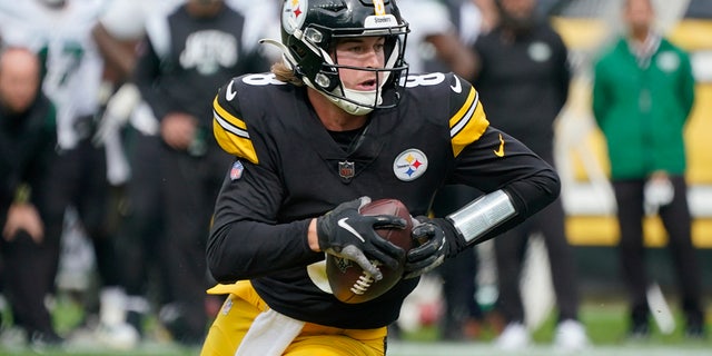 Pittsburgh Steelers quarterback Kenny Pickett, #8, scrambles against the New York Jets during the second half of an NFL football game, Sunday, Oct. 2, 2022, in Pittsburgh. 