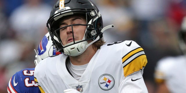 Pittsburgh Steelers quarterback Kenny Pickett is hit by Buffalo Bills linebacker Tyrel Dodson and Siran Neal after getting off a pass during the second half of a game in Orchard Park, N.Y., Sunday, Oct. 9, 2022.