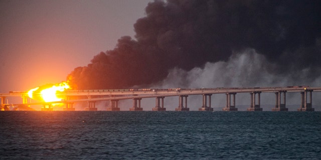 Flame and smoke rise from the Crimean Bridge connecting Russian mainland and the Crimean peninsula over the Kerch Strait, in Kerch, Crimea, Oct. 8, 2022. Russian authorities say a truck bomb has caused a fire and the partial collapse of a bridge linking Russia-annexed Crimea with Russia. 