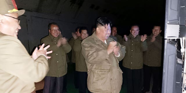 In this photo provided by the North Korean government, North Korean leader Kim Jong Un, center, supervises tests of long-range cruise missiles at an undisclosed location in North Korea Wednesday, Oct. 12, 2022.