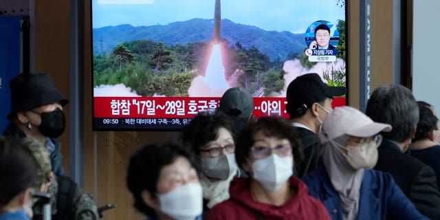 A TV screen shows a file image of North Korea's missile launch during a news program at the Seoul Railway Station in Seoul, South Korea, Friday, Oct. 14, 2022.