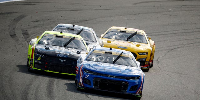 Kyle Larson, driver of the No. 5 HendrickCars.com Chevrolet; Austin Cindric, driver of the No. 2 Menards/Richmond Ford; Todd Gilliland, driver of the No. 38 First Phase Ford; and Joey Logano, driver of the No. 22 Shell Pennzoil Ford, race during the NASCAR Cup Series Bank of America Roval 400 at Charlotte Motor Speedway Oct. 9, 2022, in Concord, N.C.