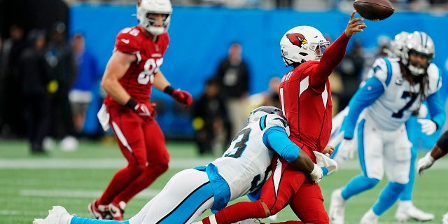 Arizona Cardinals quarterback Kyler Murray passes under pressure from Carolina Panthers defensive end Brian Burns during the second half of an NFL football game on Sunday, Oct. 2, 2022, in Charlotte, N.C.