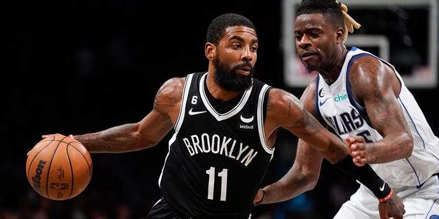 Brooklyn Nets guard Kyrie Irving drives against Dallas Mavericks forward Reggie Bullock, Thursday, Oct. 27, 2022, in New York.