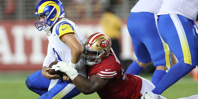 Los Angeles Rams quarterback Matthew Stafford, left, is sacked by San Francisco 49ers defensive tackle Hassan Ridgeway during the second half of an NFL football game in Santa Clara, Calif., Monday, Oct. 3, 2022.