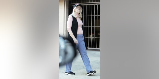 The "Cheers" alum was seen wearing a light pink turtleneck with a long black sweater vest over it, grey sweatpants, sneakers, glasses and a black baseball cap. 