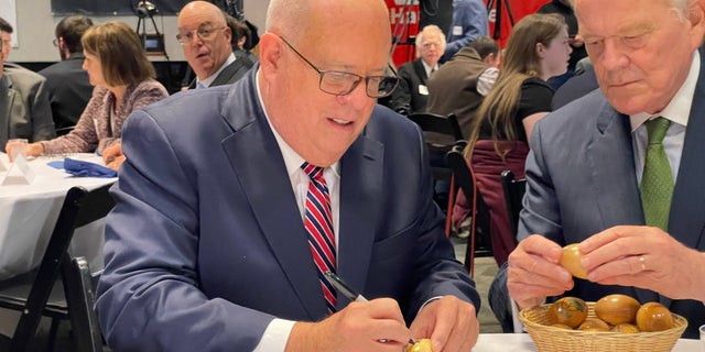 Republican Gov. Larry Hogan of Maryland signs the iconic wooden eggs before addressing "Politics and Eggs," on Oct. 6, 2022. The speaking series at the New Hampshire Institute of Politics is a must stop for potential or actual White House hopefuls.