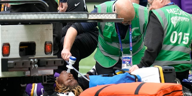 Minnesota Vikings safety Lewis Cine (6) receives treatment after an injury during an NFL match between the Minnesota Vikings and New Orleans Saints at the Tottenham Hotspur stadium in London, Sunday, Oct. 2, 2022.