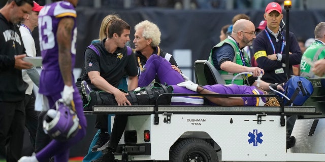 Minnesota Vikings safety Lewis Cine (6) is taken from the field after an injury during an NFL match between the Minnesota Vikings and New Orleans Saints at the Tottenham Hotspur stadium in London, Sunday, Oct. 2, 2022.