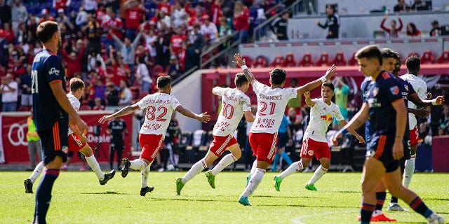 New York Red Bulls midfielder Lewis Morgan (10), center, celebrates with teammates after scoring a goal against the FC Cincinnati during the second half of an MLS soccer playoff match, Saturday, Oct. 15, 2022, in Harrison, N.J.