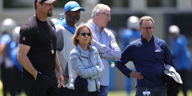 Principal owner Sheila Ford Hamp watches a practice with head coach Dan Campbell, left, general manager Brad Holmes and President Rod Woods May 27, 2021, in Allen Park, Mich.