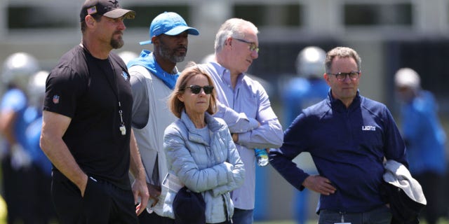 Principal owner Sheila Ford Hamp watches a practice with head coach Dan Campbell, left, general manager Brad Holmes and President Rod Woods May 27, 2021, in Allen Park, Mich.