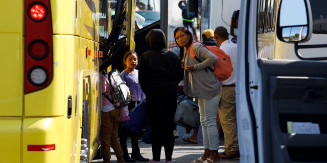 Venezuelan migrants gather at the Vineyard Haven ferry terminal. The group was transported to Joint Base Cape Cod in Buzzards Bay in Massachusetts.