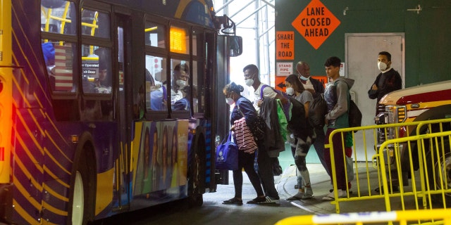 Migrants leave for a shelter from the Port Authority bus terminal in New York on Sept. 27, 2022.