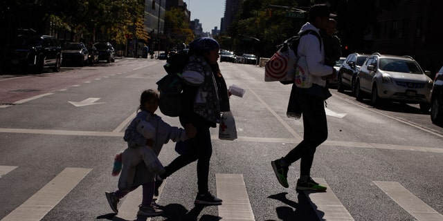 Venezuelan asylum seekers leave an immigrants information center in Manhattan Oct. 9, 2022, in New York City. 