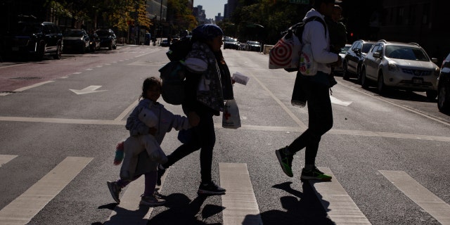 Venezuelan asylum seekers leave an Immigrants Information center in Manhattan on October 9, 2022 in New York City.